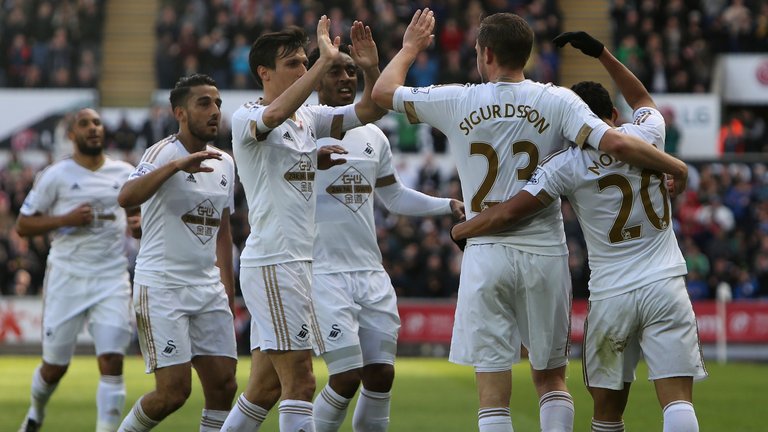Swansea players celebrate Sigurdsson's goal