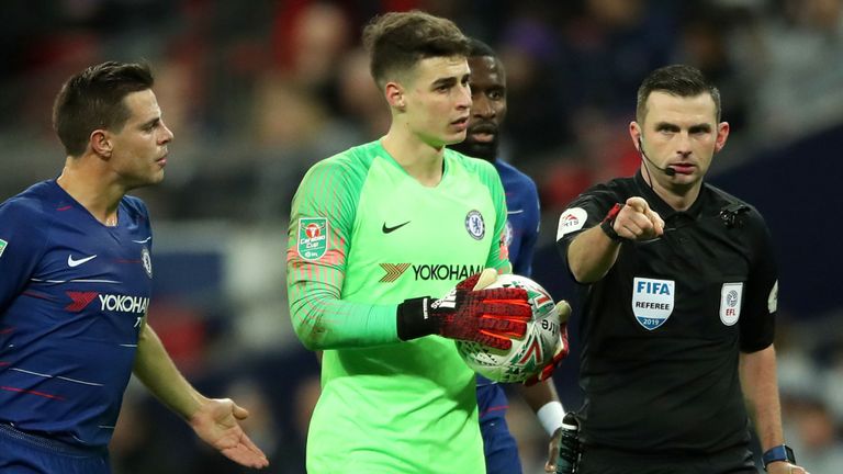 Michael Oliver points to the spot
